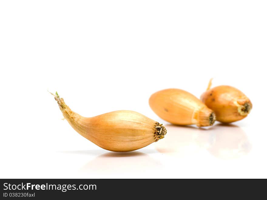 Three onions isolated on white background. Three onions isolated on white background.