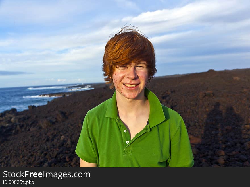 Boy walking in volcanic area