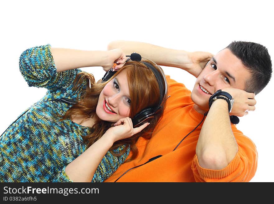 Smiling young people listen to music isolated on white