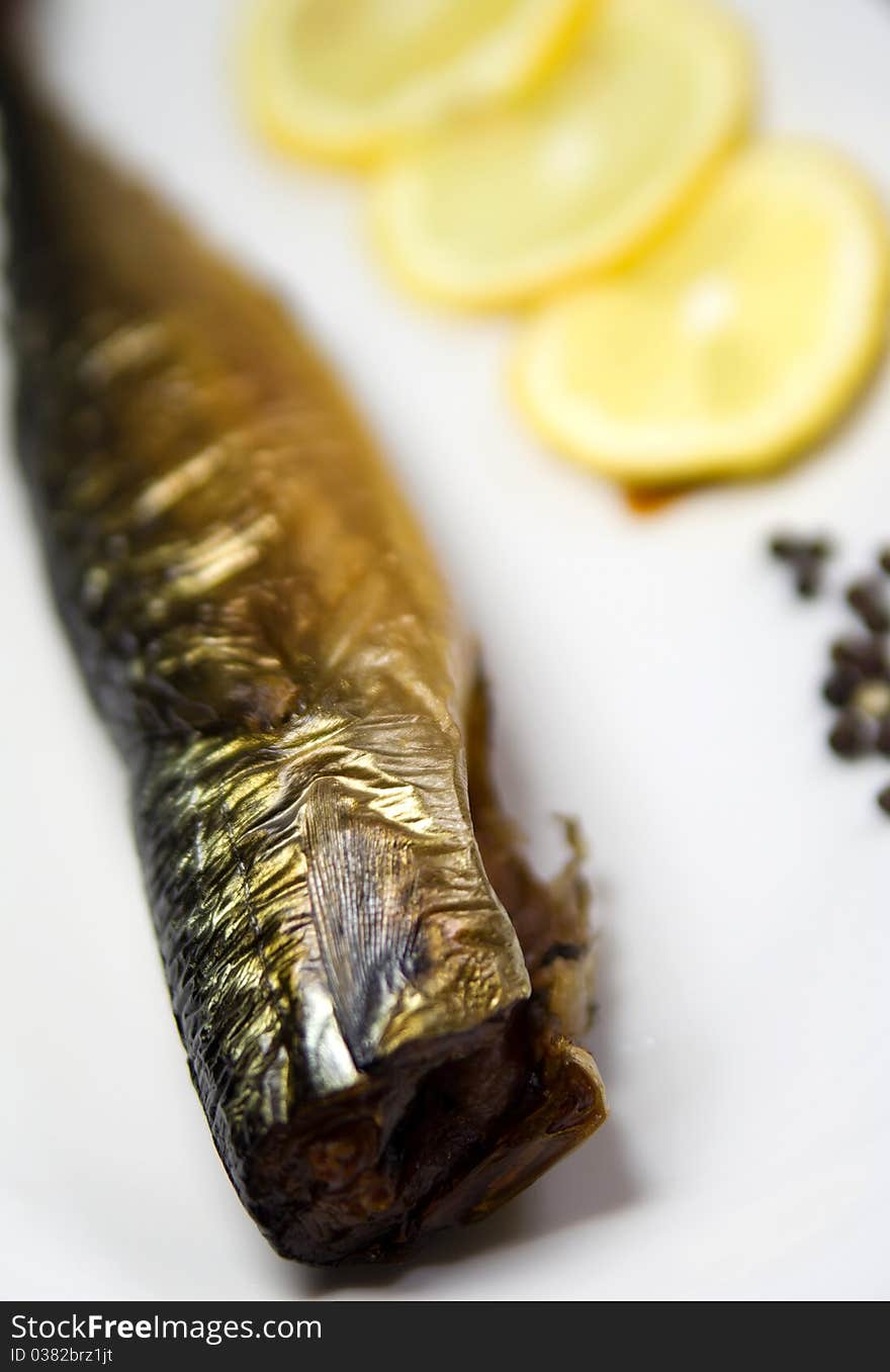 Smoked fish, on white plate, with, lemon