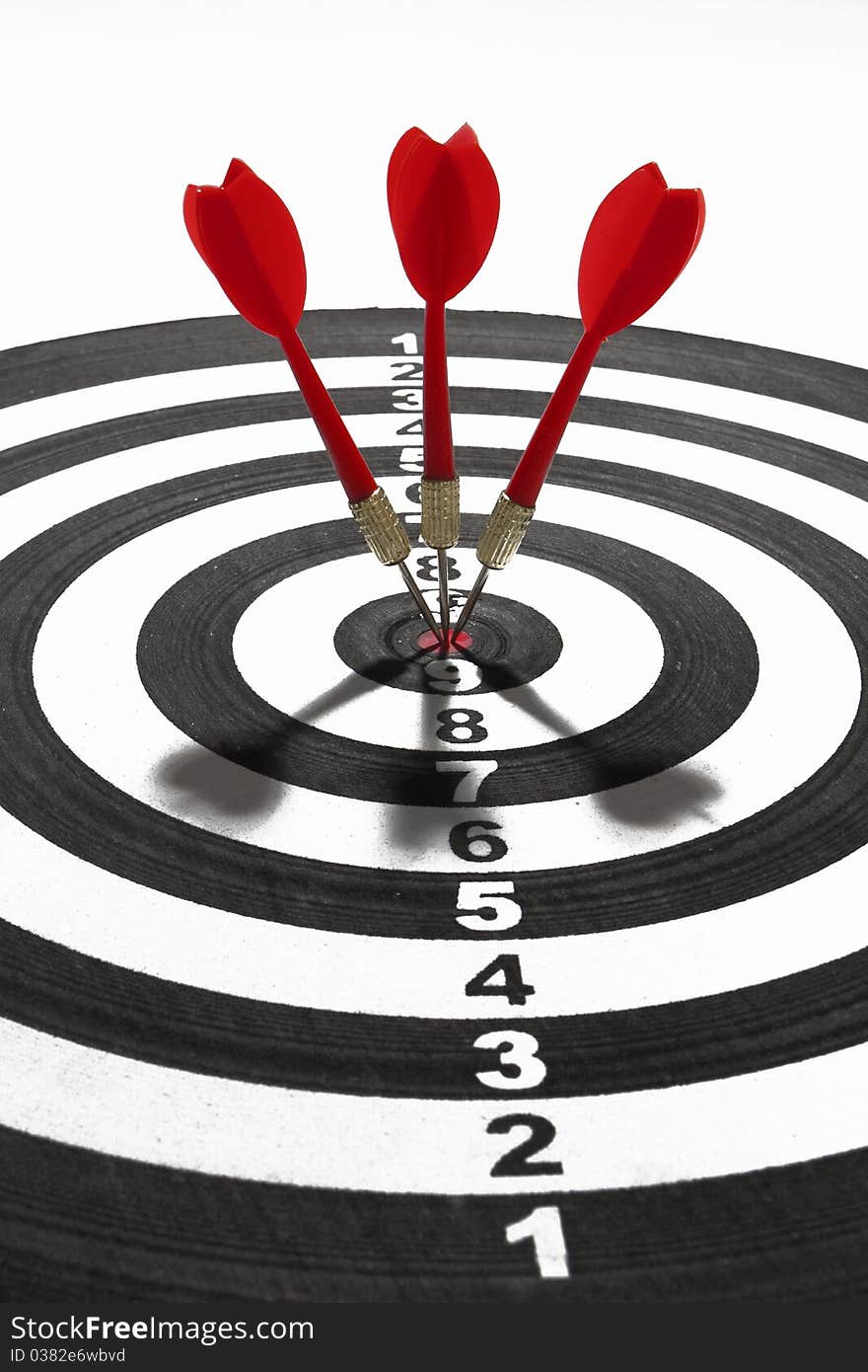 Three red darts hitting a target board, concept for business success and marketing