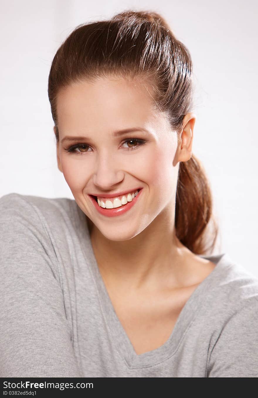 Closeup portrait of a happy young woman smiling. Closeup portrait of a happy young woman smiling