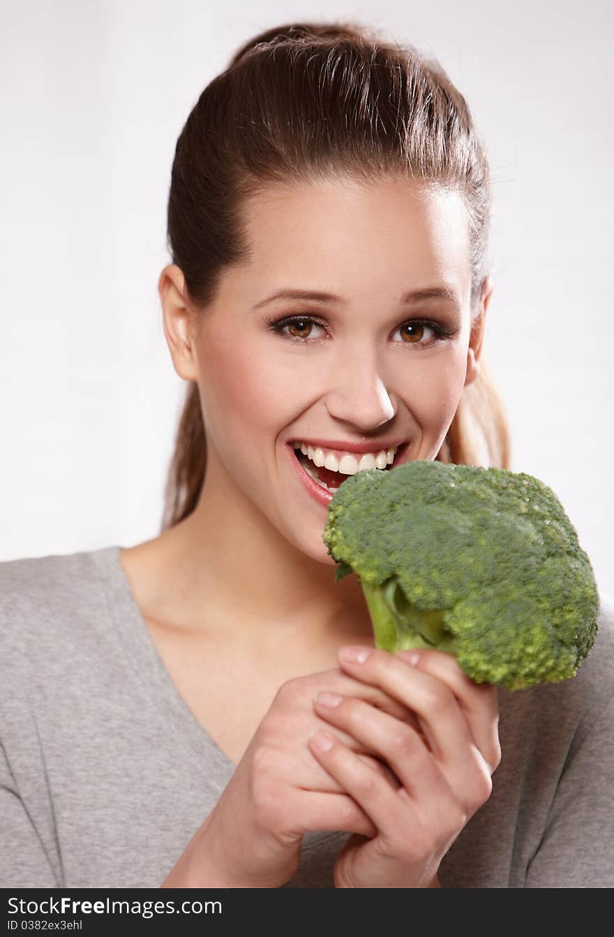 Portrait of a beautiful smiling woman with broccoli, isolated on white. Portrait of a beautiful smiling woman with broccoli, isolated on white