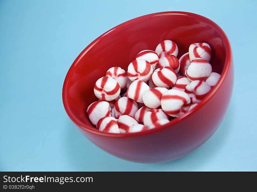 Peppermint candies shot on red plate. Plenty of space for copy and design elements. Peppermint candies shot on red plate. Plenty of space for copy and design elements.