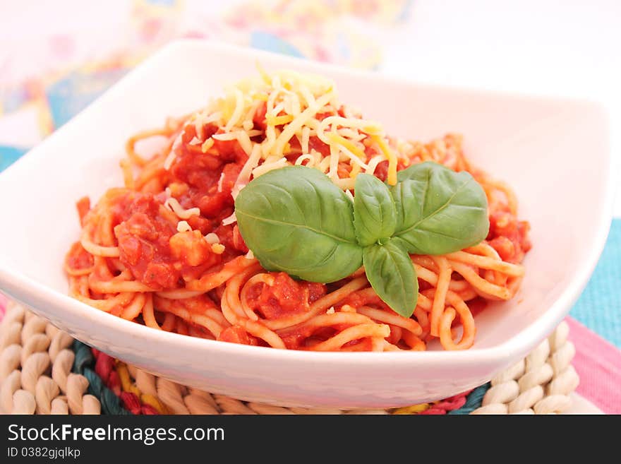 Spaghettis with tomatoes sauce and bacon on a plate