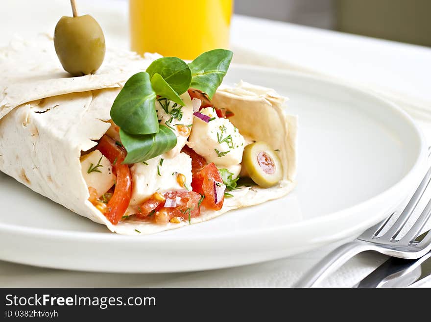 Lavash with a cheese filling, tomato, spinach, olives and a glass of juice. Lavash with a cheese filling, tomato, spinach, olives and a glass of juice.