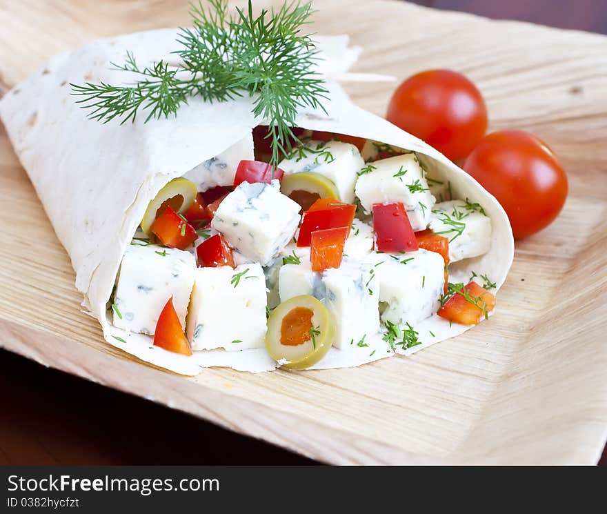 Lavash with a cheese filling, tomato, peppers, olives and fennel. Lavash with a cheese filling, tomato, peppers, olives and fennel.