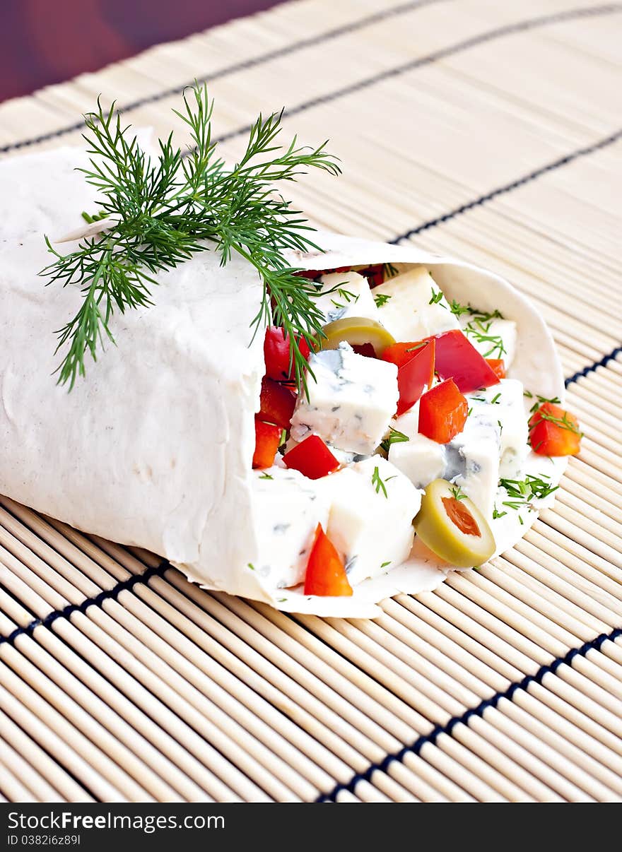 Lavash with a cheese filling, tomato, peppers, olives and fennel. Lavash with a cheese filling, tomato, peppers, olives and fennel.