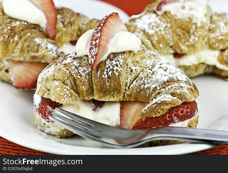 Fresh croissant with strawberries and cream. Fresh croissant with strawberries and cream