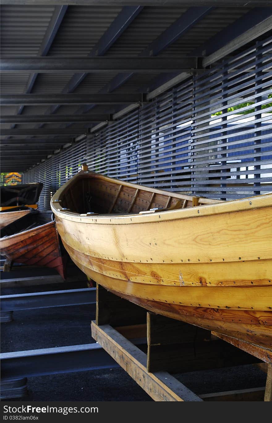 Yellow woodenBoat in a boathouse.