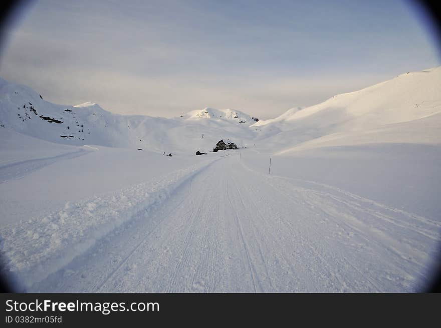 Faraway hut surrounded by snow in the mountains, Dolomites, Italy