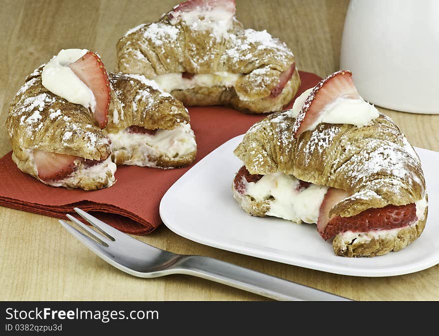 Fresh croissant with strawberries and cream. Fresh croissant with strawberries and cream