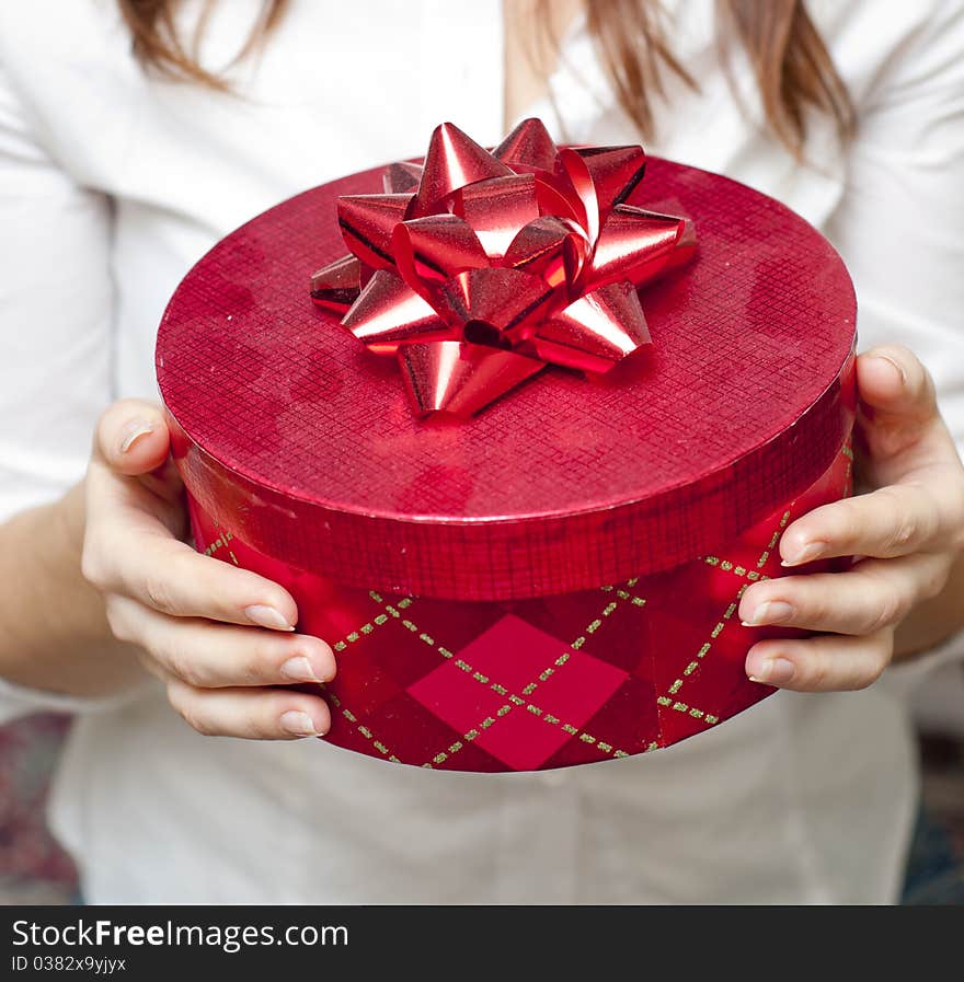 Red box holding in hand of young girl