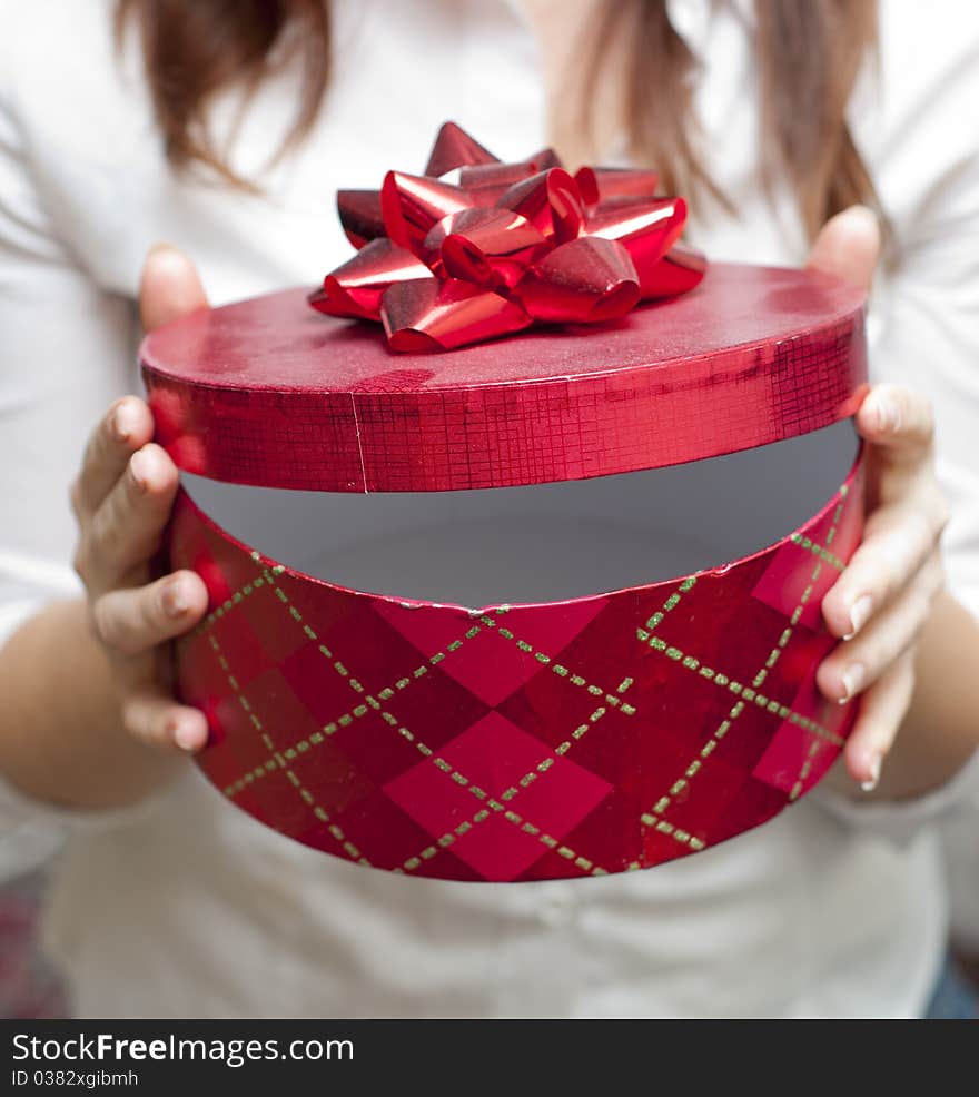 Red box holding in hand of young girl