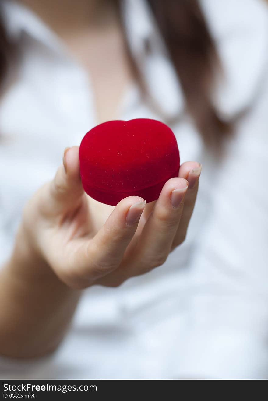 Red engagement box holding by hand of young girl