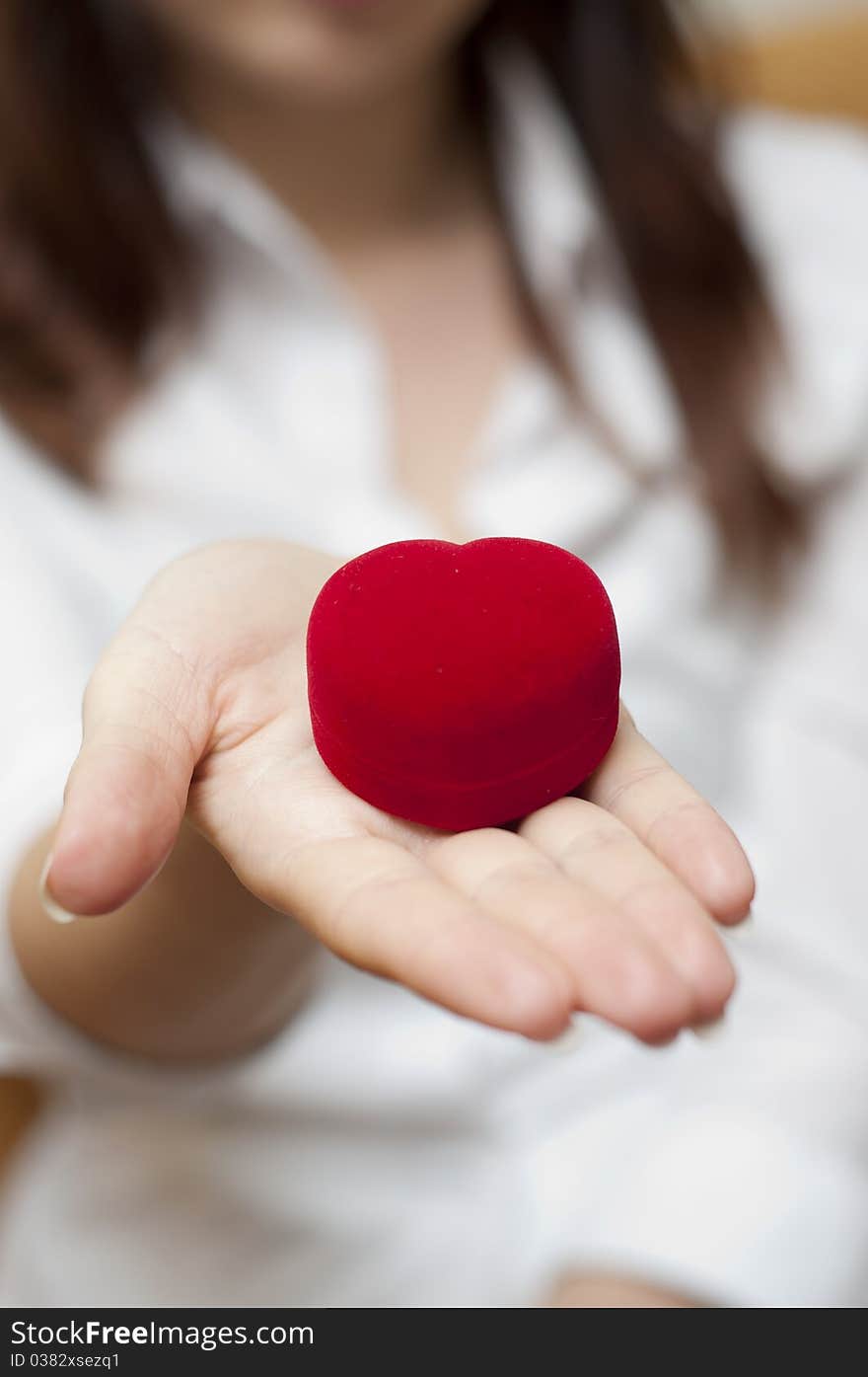 Red engagement box holding by hand of young girl