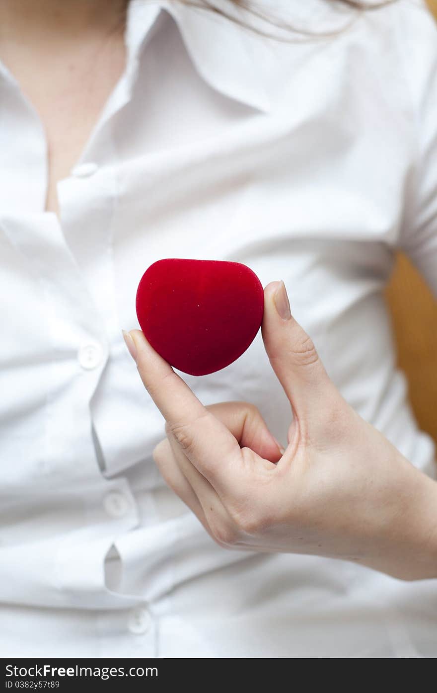 Red engagement box holding by hand of young girl