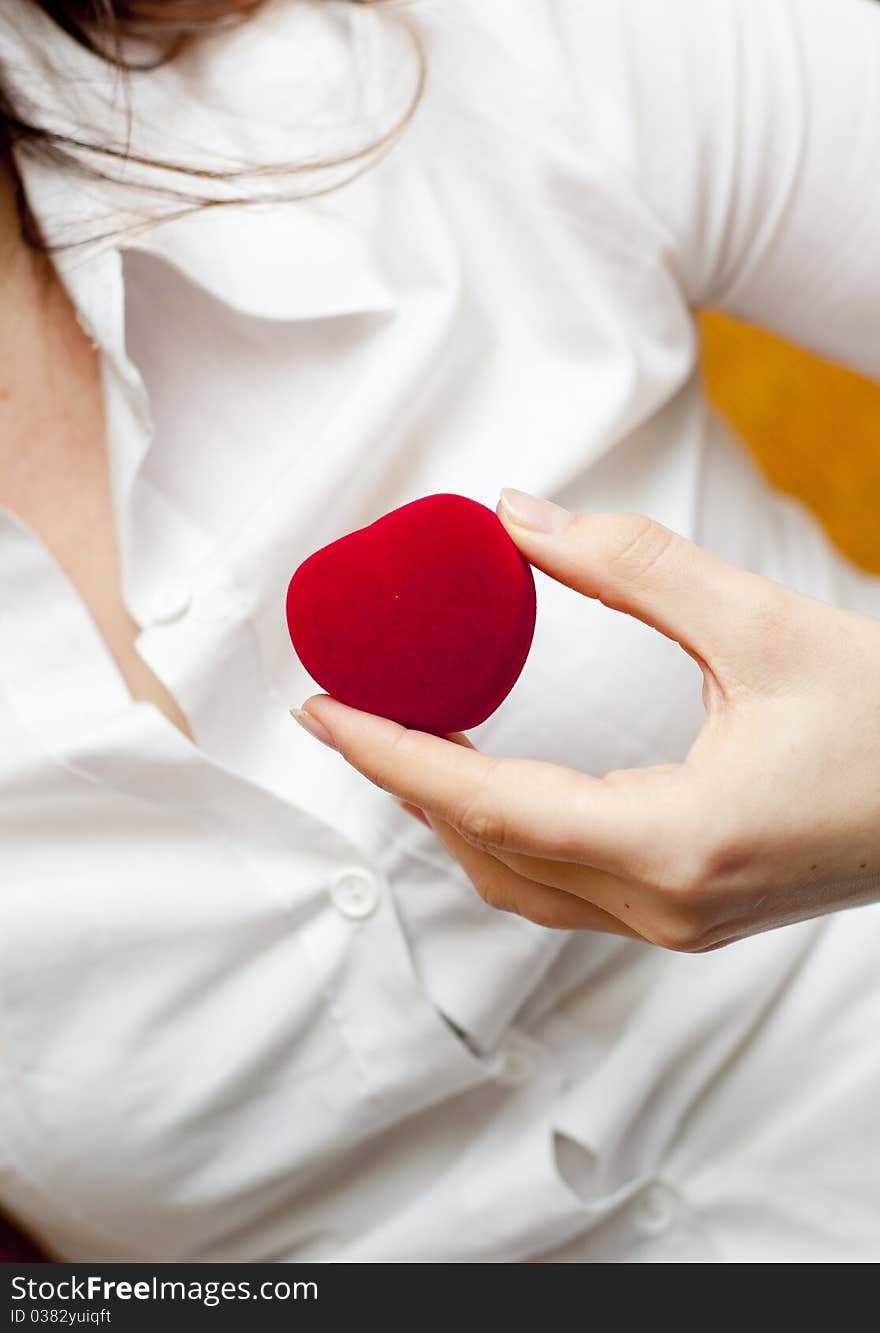 An image of red engagement box holding by hand of young girl