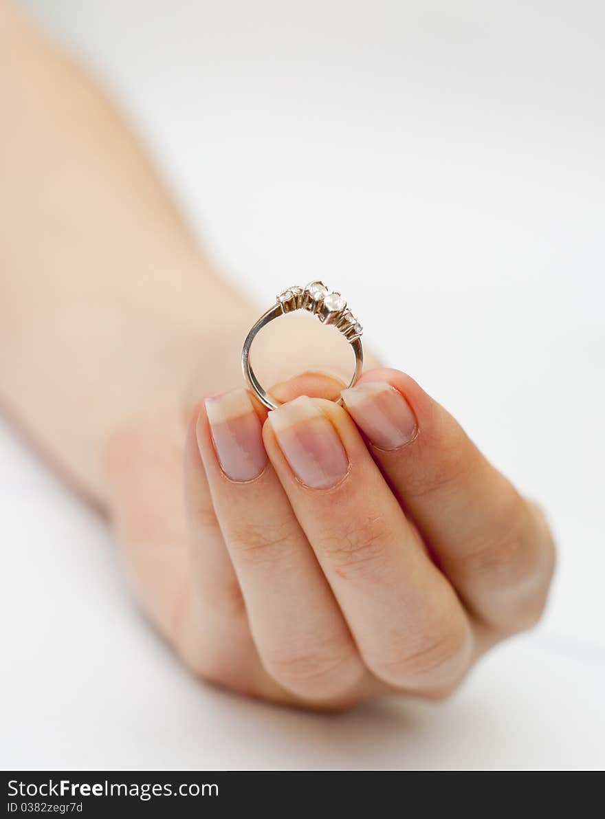 An image of engagement ring held in hand