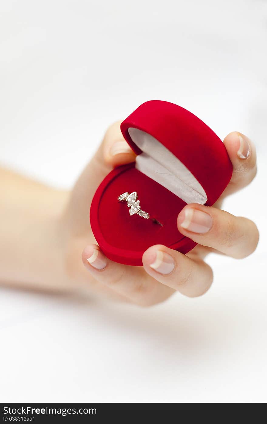 Red Box With Engagement Ring Inside Held In Hand