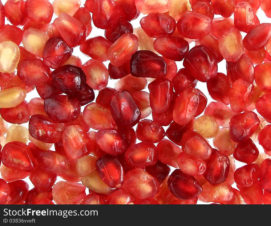 Pomegranate seeds on white background