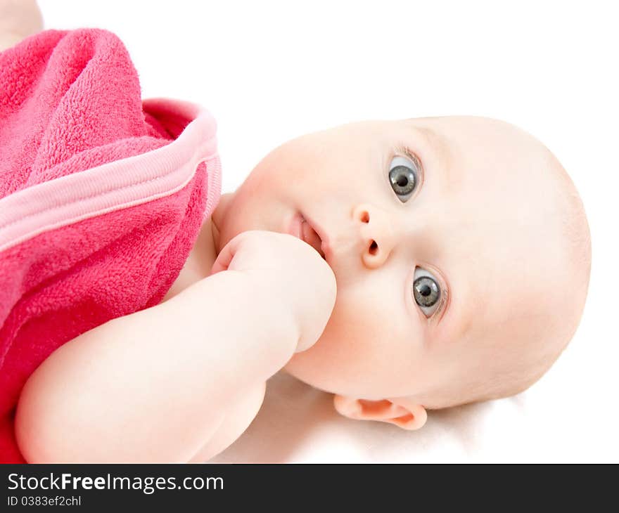 Surprised kid looks at a white background.