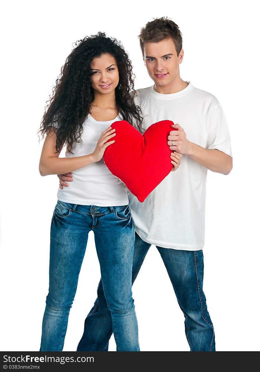 Young couple with a heart over white background