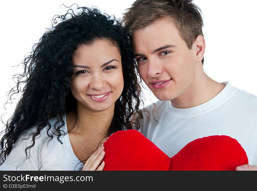 Young couple with a heart over white background