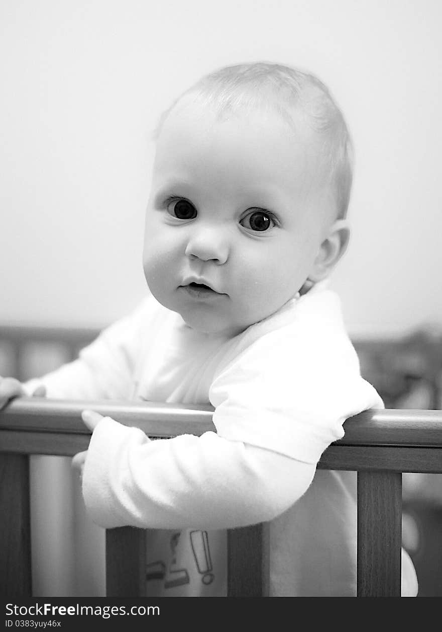 Cute baby boy in his cot