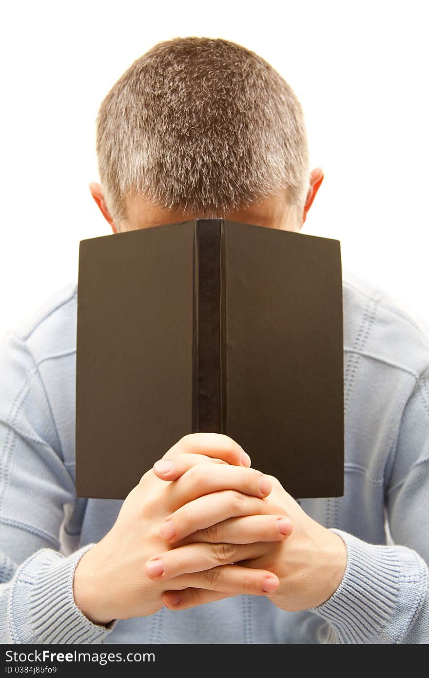 Young man with book on face. Young man with book on face