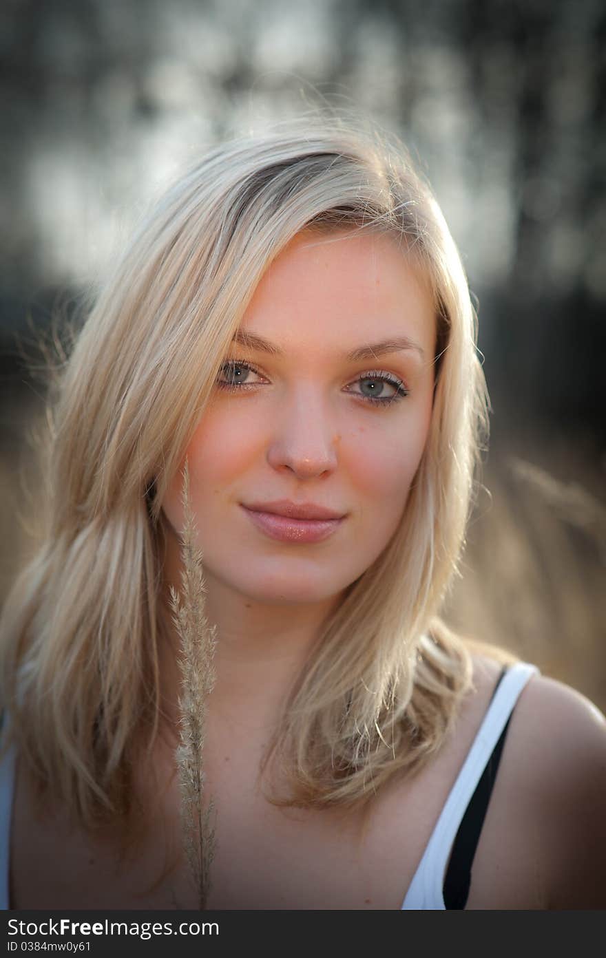 Portrait of a beautiful blonde woman with long hair and a smile