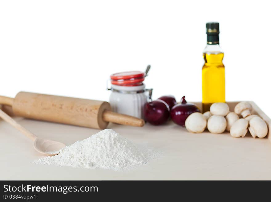 Pizza (bread) dough, olive oil, rolling pin with herbs and vegetables. Pizza (bread) dough, olive oil, rolling pin with herbs and vegetables