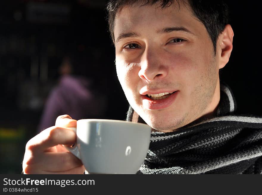 Young man enjoying a cup of coffee. Young man enjoying a cup of coffee