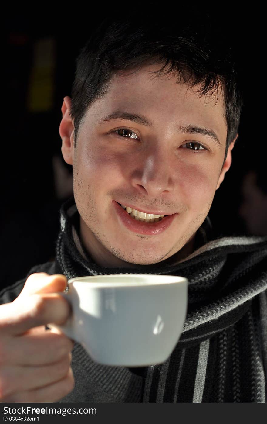 Young man enjoying a cup of coffee. Young man enjoying a cup of coffee