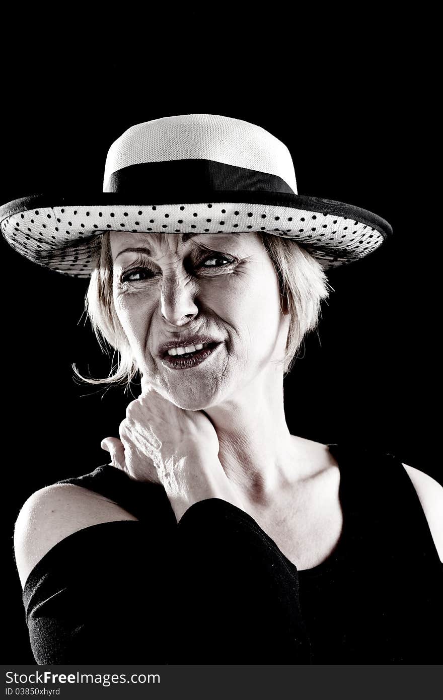 Woman with hat performing on stage, black background. Woman with hat performing on stage, black background