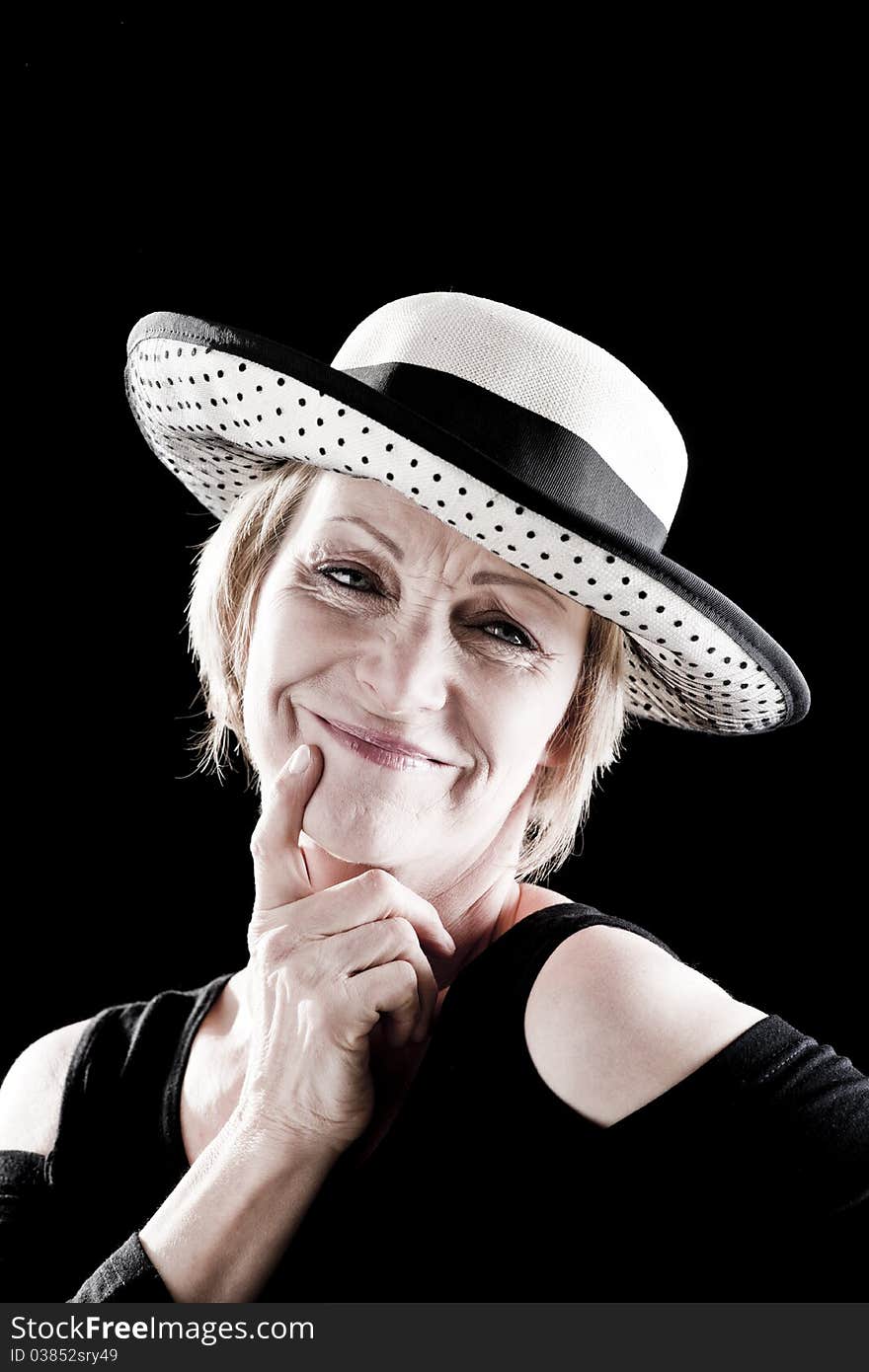 Woman with hat performing on stage, black background. Woman with hat performing on stage, black background