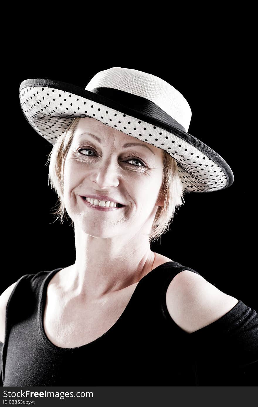 Woman with hat performing on stage, black background. Woman with hat performing on stage, black background