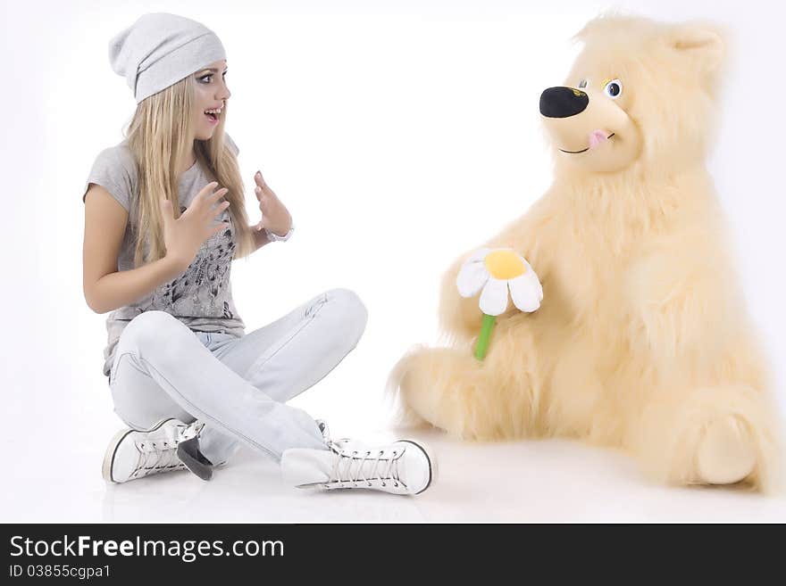 Emotional, glamour girl with a toy on a white background