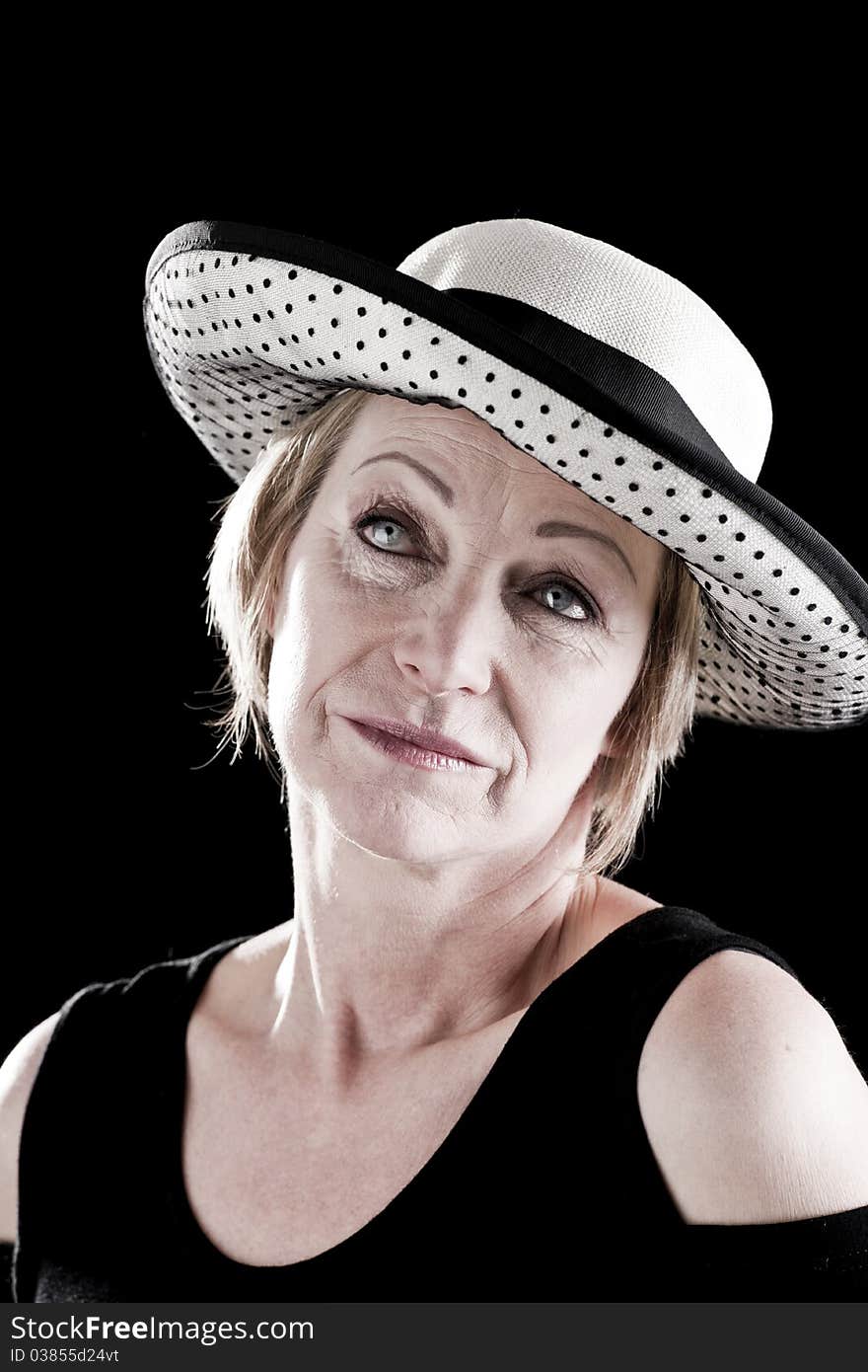 Woman with hat performing on stage, black background. Woman with hat performing on stage, black background