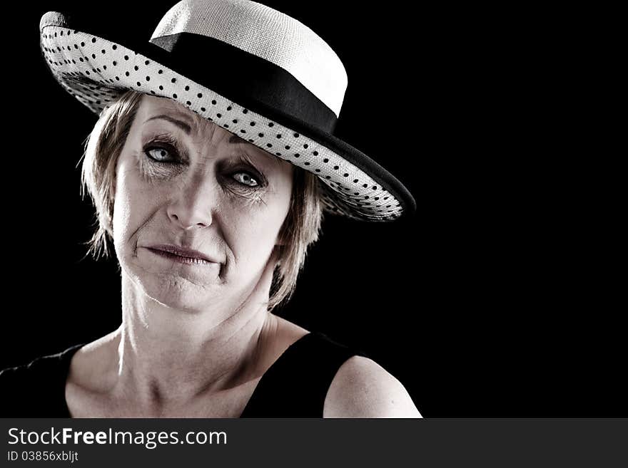 Woman with hat performing on stage, black background. Woman with hat performing on stage, black background