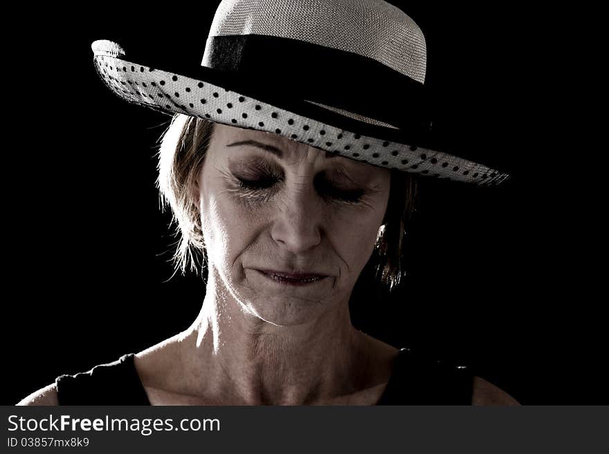 Woman with hat performing on stage, black background. Woman with hat performing on stage, black background