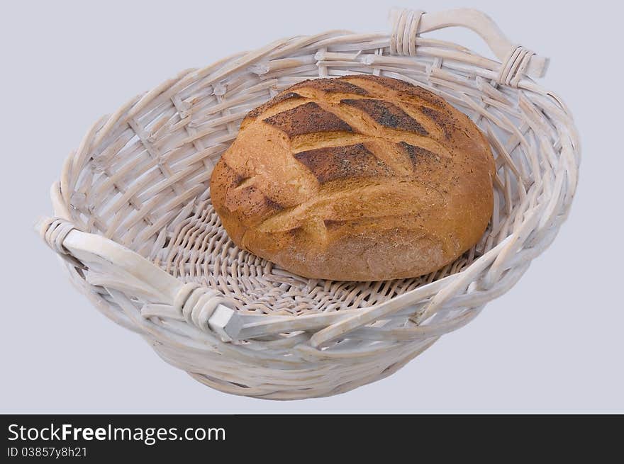 Round loaf of bread in wicker basket. Round loaf of bread in wicker basket