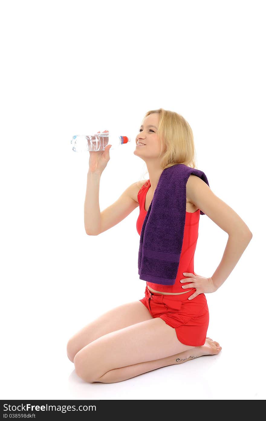 Pretty fitness woman drinking water after training exercises. isolated on white background