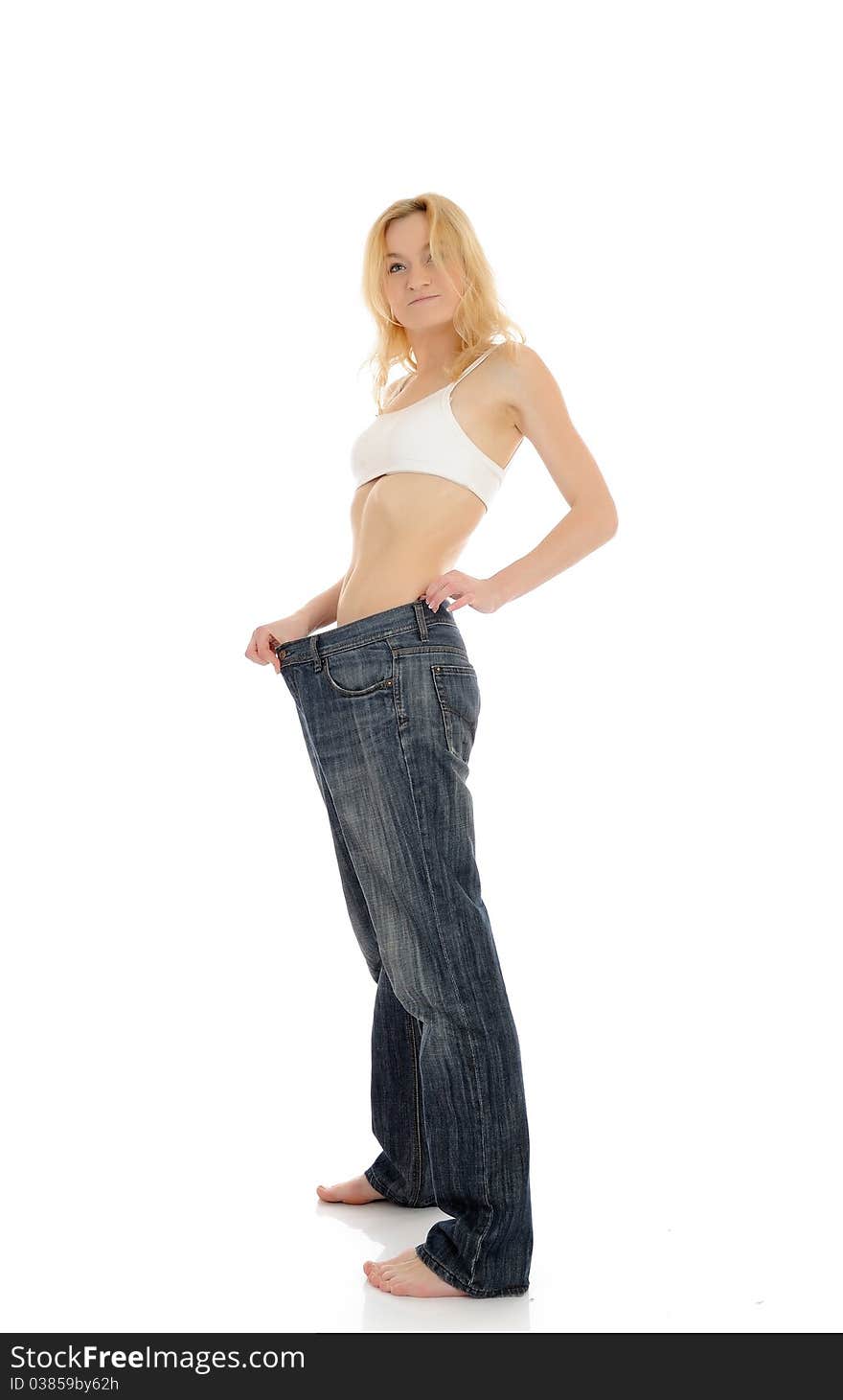 Slim woman in oversized big pants lost her weight. isolated on white background. Slim woman in oversized big pants lost her weight. isolated on white background