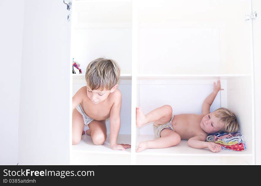 Two children on book shelves. Two children on book shelves