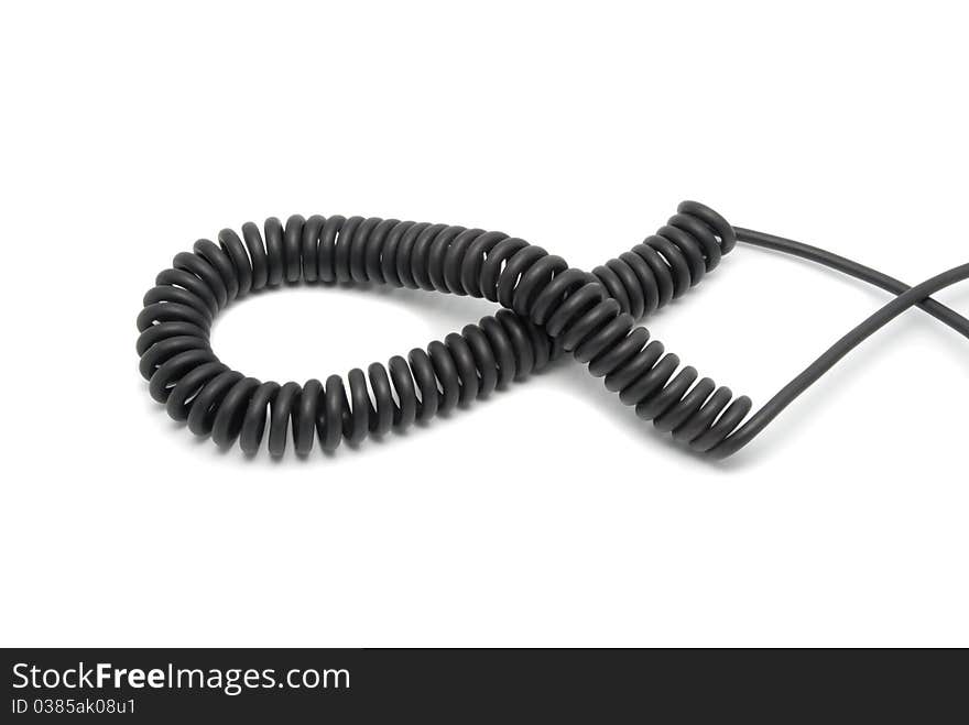 Black telephone cord in the form of a spring. On a white background