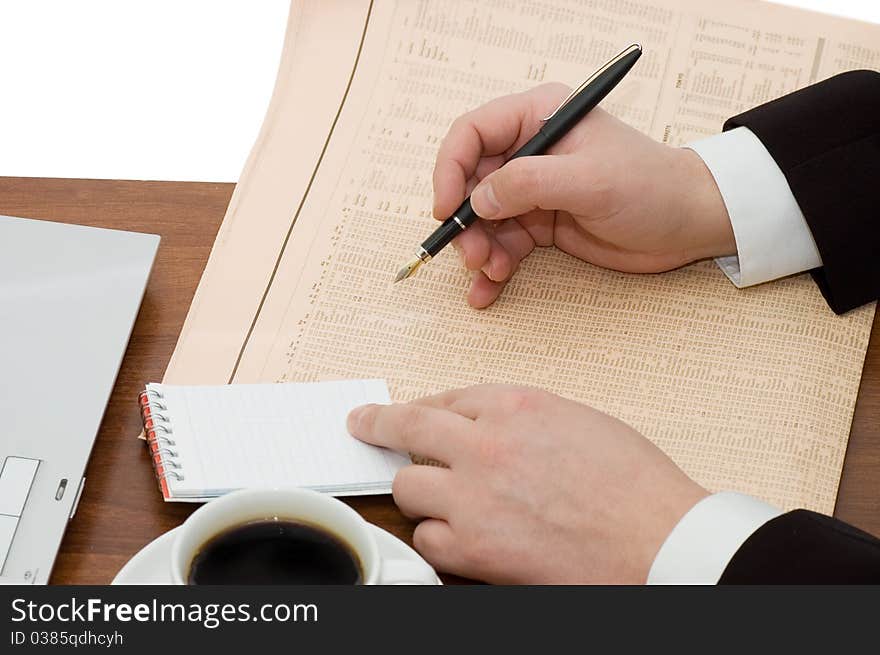 The businessman behind a cup from coffee close up