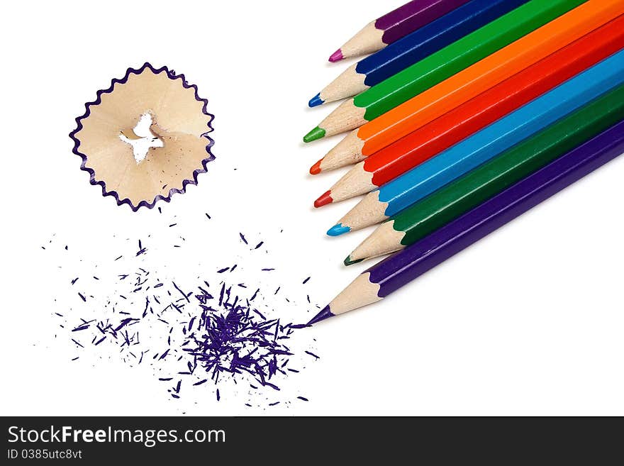 The grinded color pencils are isolated on a white background