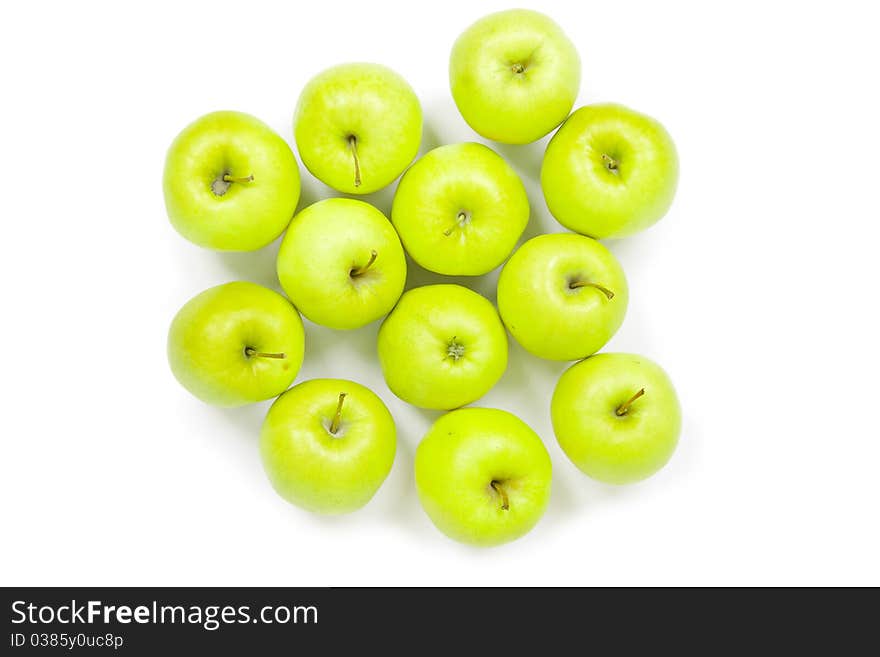 Green and yellow apples on a white baclground