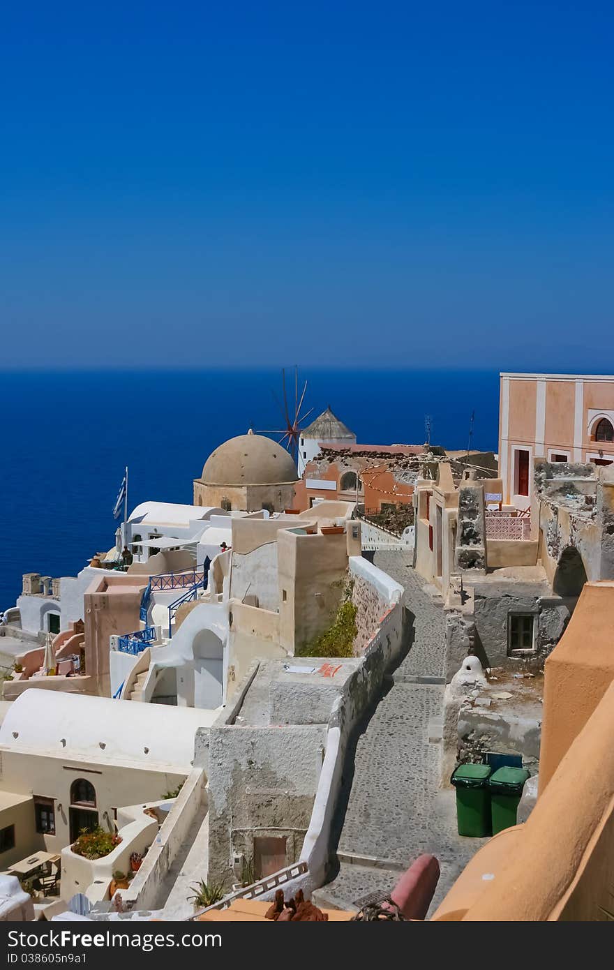 Beautiful view on the street in Santorini, Oia. Aegean sea in a background, Greece. Beautiful view on the street in Santorini, Oia. Aegean sea in a background, Greece.